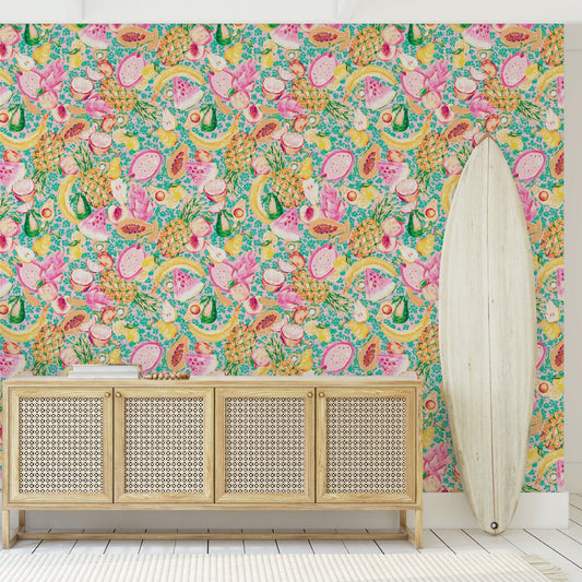 wallpaper hand painted with watercolors, blue based print with white ditsy florals with tossed fruit layered on top including: pineapples, limes, bananas, avocados, lemons, pears, peaches, watermelon, coconuts, mangos, bananas passion fruit Natural Textured Eco-Friendly Non-toxic High-quality Sustainable practices Sustainability Interior Design Wall covering Bold tropical retro chic garden linen