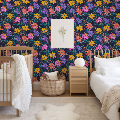 Evening Bloom Firefly Social floral wallpaper in a shared kids room with a wooden crib, nightstand and rattan bed