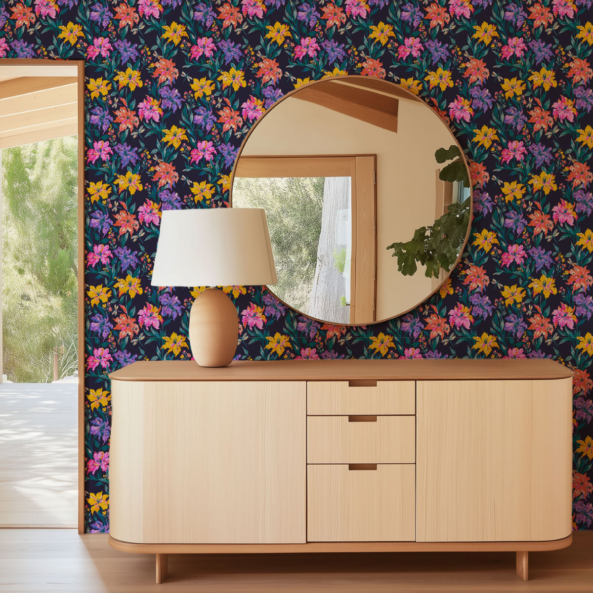 Evening Bloom Firefly Social floral wallpaper in an entry with a round mirror, lamp and light wood sideboard