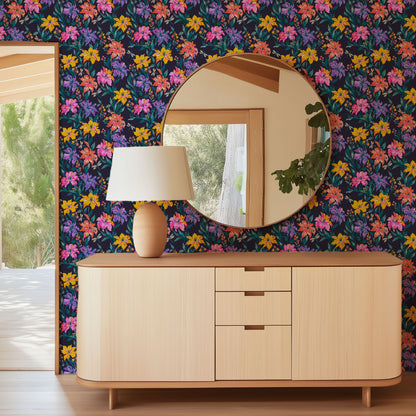 Evening Bloom Firefly Social floral wallpaper in an entry with a round mirror, lamp and light wood sideboard