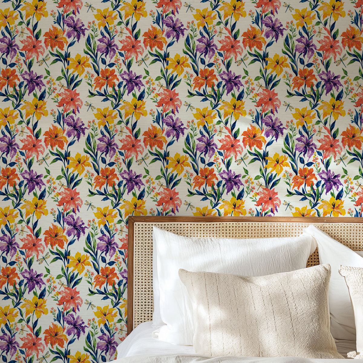 Golden Hour Firefly Social floral wallpaper behind a cane headboard with white and linen bedding